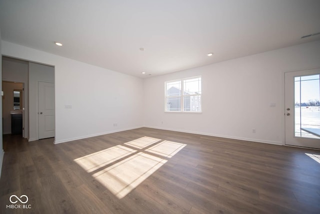 spare room featuring dark hardwood / wood-style floors