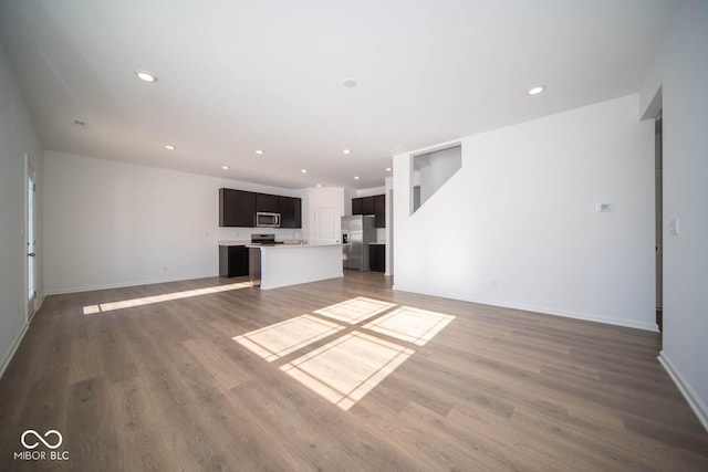 unfurnished living room with dark hardwood / wood-style flooring