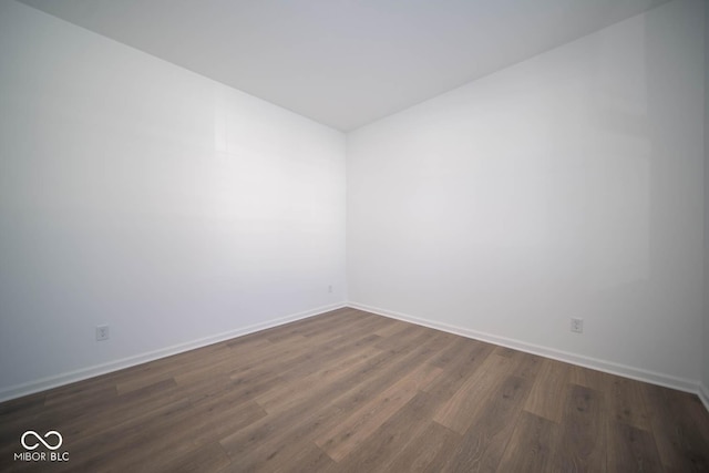 unfurnished room with dark hardwood / wood-style floors