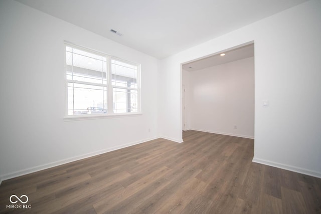 spare room featuring dark hardwood / wood-style flooring