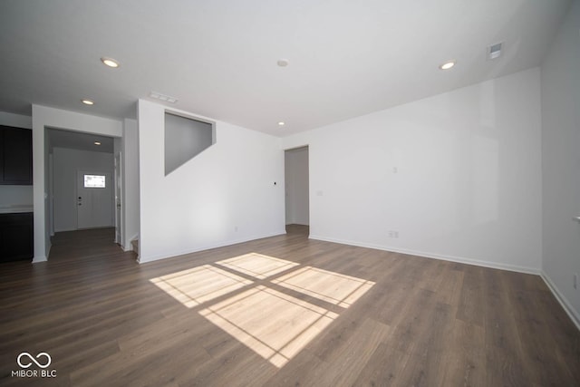 unfurnished room with dark hardwood / wood-style flooring