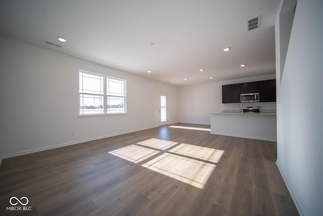 unfurnished living room featuring dark wood-type flooring