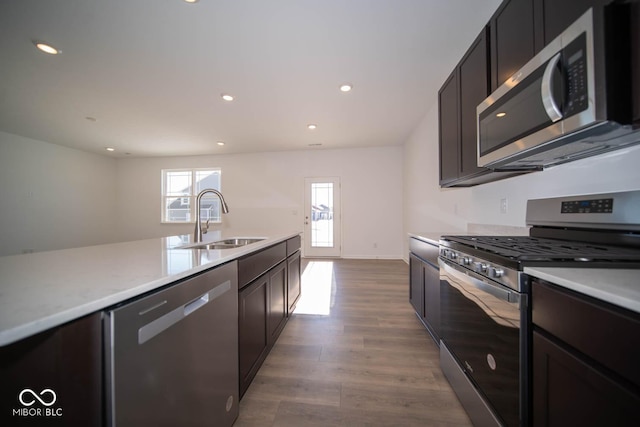 kitchen featuring sink, appliances with stainless steel finishes, and light hardwood / wood-style flooring