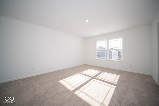 unfurnished room with light colored carpet