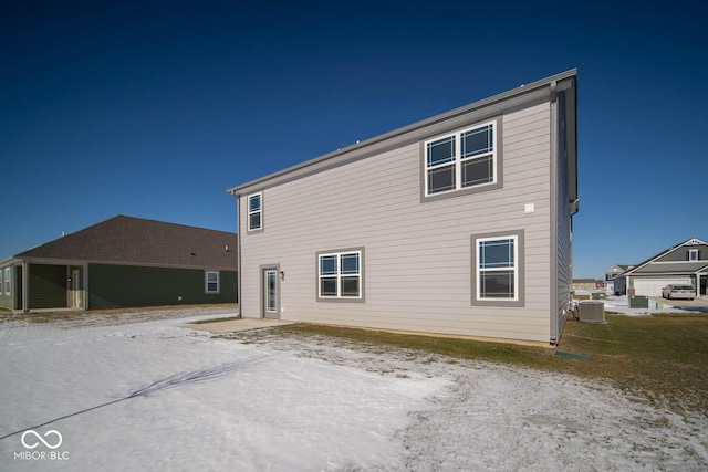 rear view of property with central AC