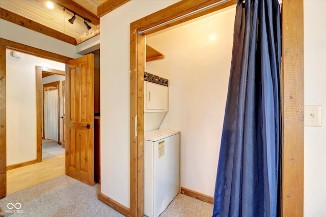 9300 Derrett Rd, Unionville, IN 47468 - laundry room featuring stacked washing machine and dryer and light colored carpet