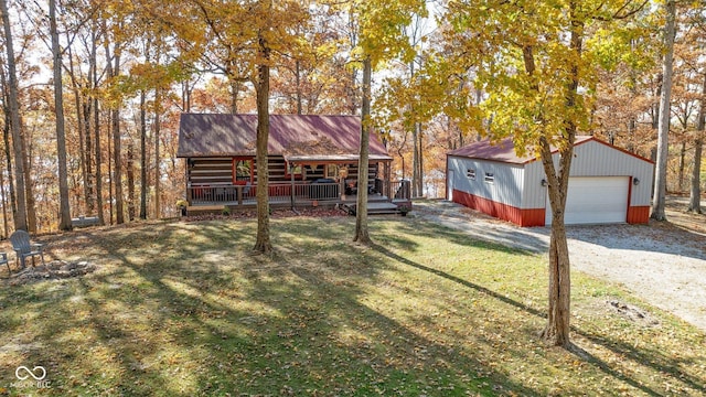 9300 Derrett Rd, Unionville, IN 47468 - view of green lawn with a detached garage, an outbuilding, a porch, and driveway