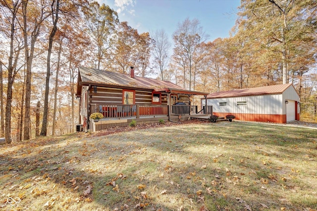 9300 Derrett Rd, Unionville, IN 47468 - rear view of house featuring a metal roof, a yard, covered porch, an outdoor structure, and a chimney