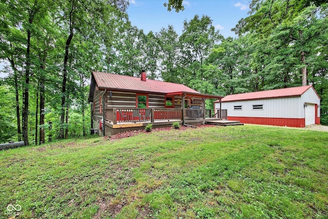 9300 Derrett Rd, Unionville, IN 47468 - rear view of house with a metal roof, a lawn, a chimney, a wooden deck, and an outbuilding