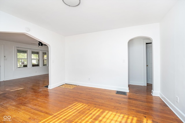 empty room featuring ceiling fan and hardwood / wood-style flooring