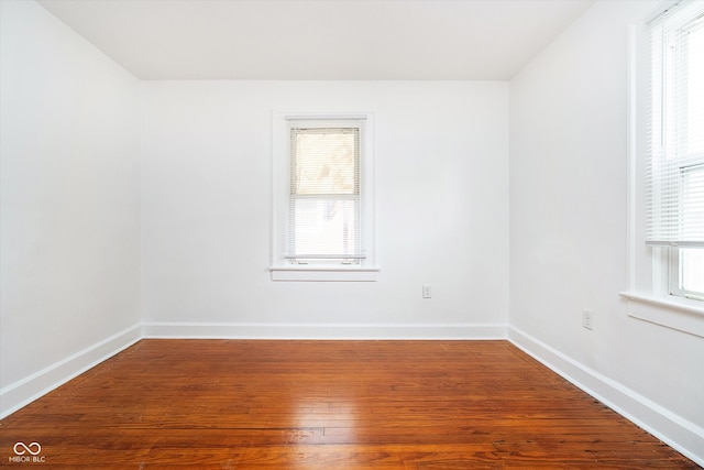 empty room featuring hardwood / wood-style flooring and plenty of natural light