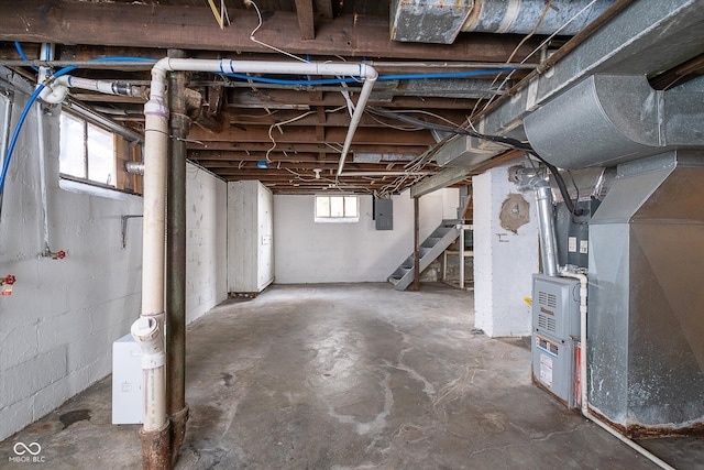 basement with electric panel and heating unit