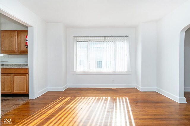 empty room with dark hardwood / wood-style floors