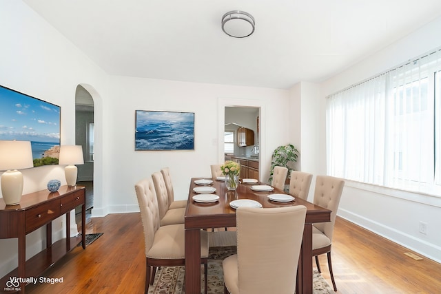 dining room featuring hardwood / wood-style floors and sink