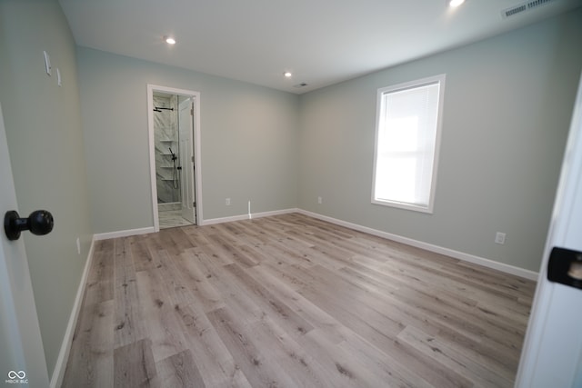 unfurnished room with light wood-type flooring