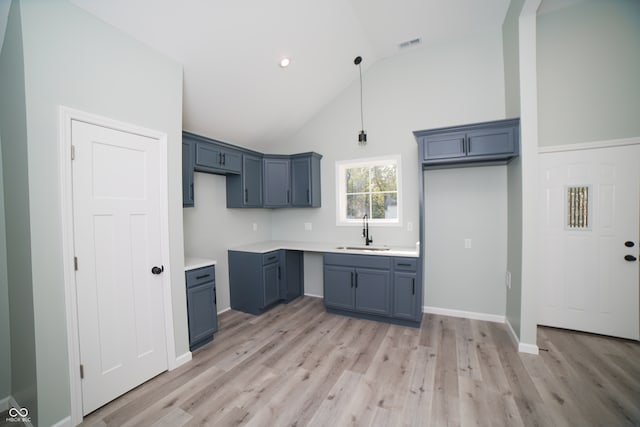 kitchen featuring light hardwood / wood-style flooring, sink, and high vaulted ceiling