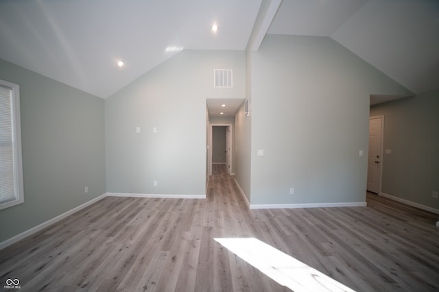 additional living space with light hardwood / wood-style floors and high vaulted ceiling