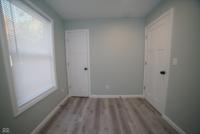 unfurnished room with light hardwood / wood-style flooring