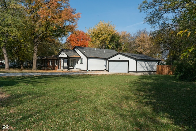 view of front of property featuring a front lawn and a garage