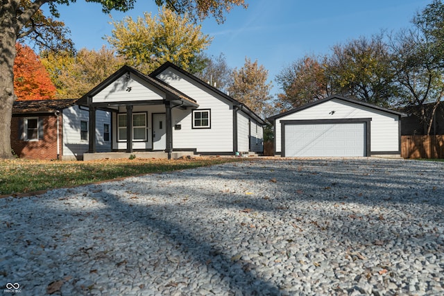 view of front of house with covered porch, cooling unit, and a garage