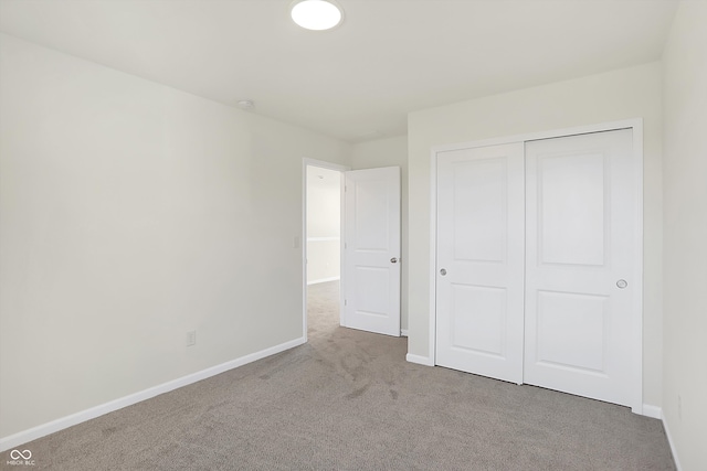 unfurnished bedroom featuring a closet and carpet floors