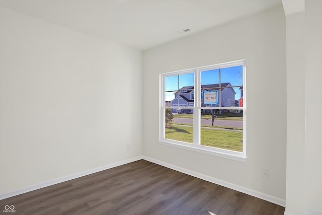 spare room featuring dark hardwood / wood-style floors