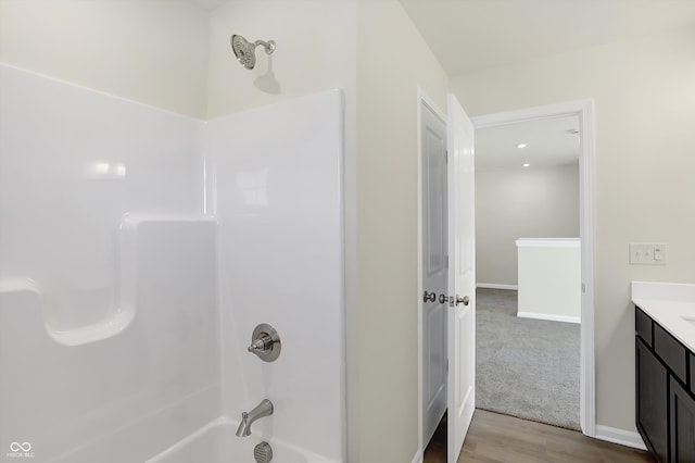 bathroom featuring vanity, shower / bathing tub combination, and wood-type flooring