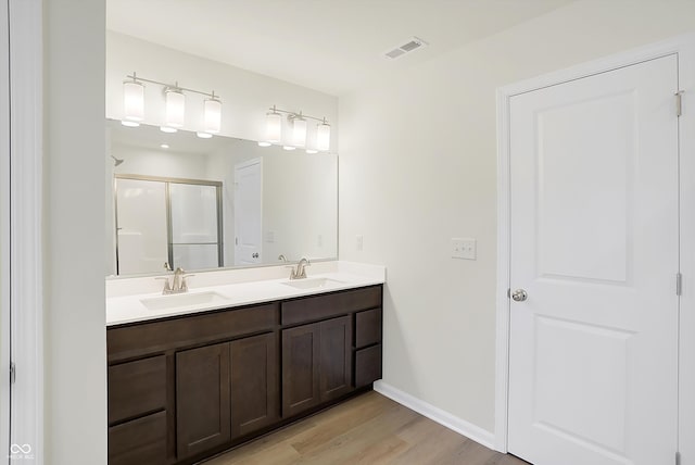 bathroom with vanity, walk in shower, and hardwood / wood-style flooring