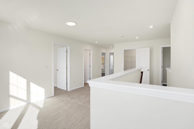 hallway with light colored carpet