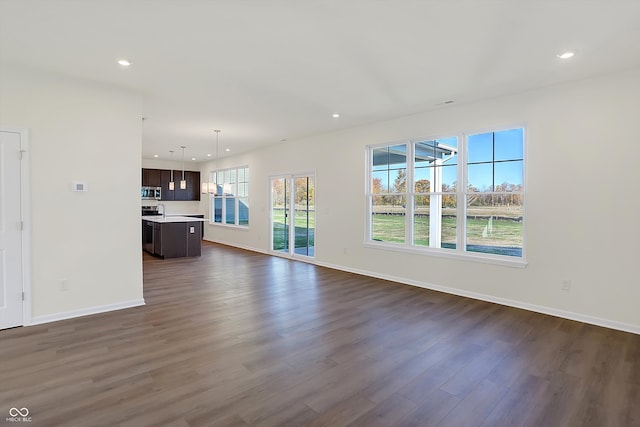 unfurnished living room featuring dark wood-type flooring