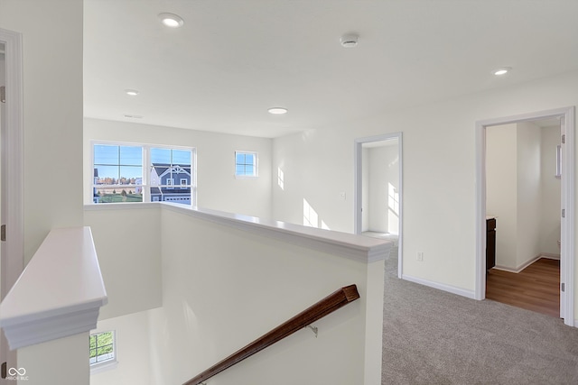 corridor featuring light colored carpet