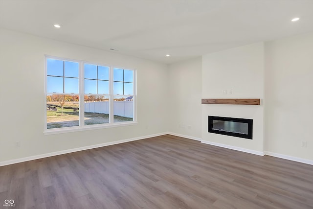 unfurnished living room with hardwood / wood-style flooring