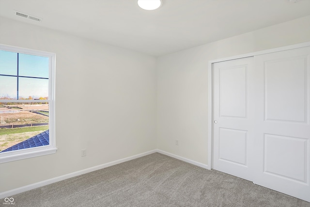 spare room with light colored carpet