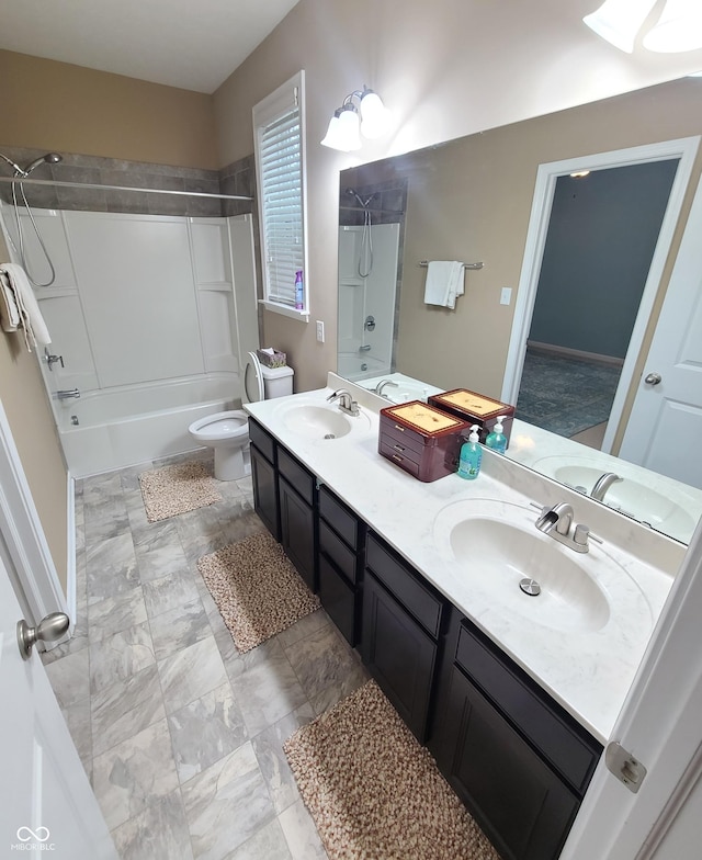 full bathroom featuring vanity, toilet, and washtub / shower combination