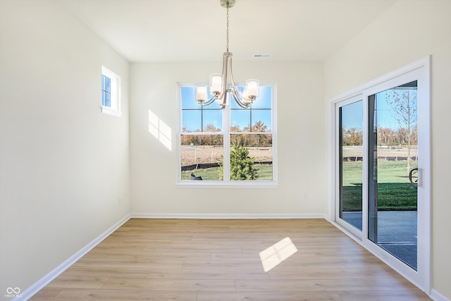 unfurnished dining area featuring a wealth of natural light and light hardwood / wood-style floors