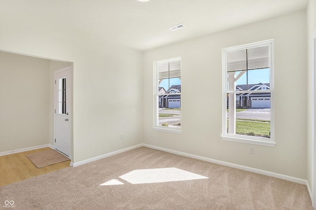 spare room with light hardwood / wood-style flooring