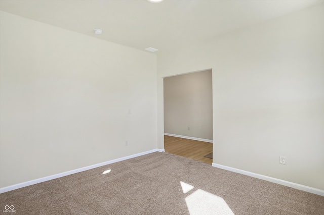 spare room featuring light carpet