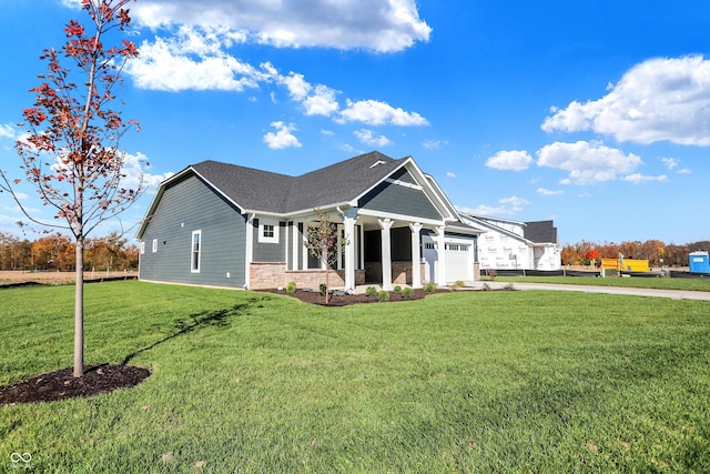 view of front of home with a front lawn and a garage