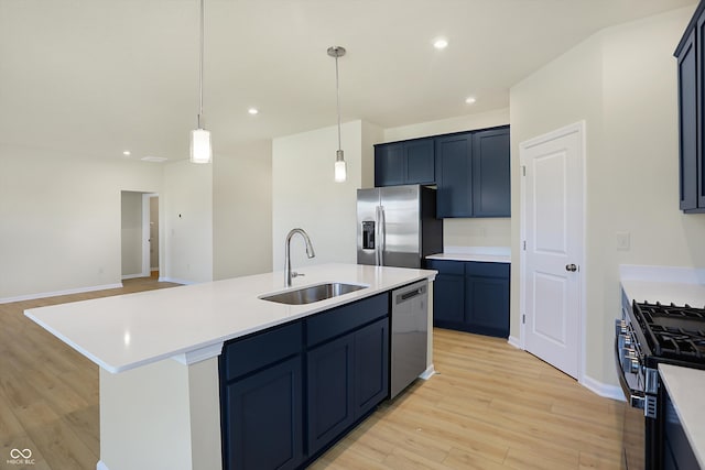 kitchen featuring sink, a kitchen island with sink, stainless steel appliances, and light hardwood / wood-style floors