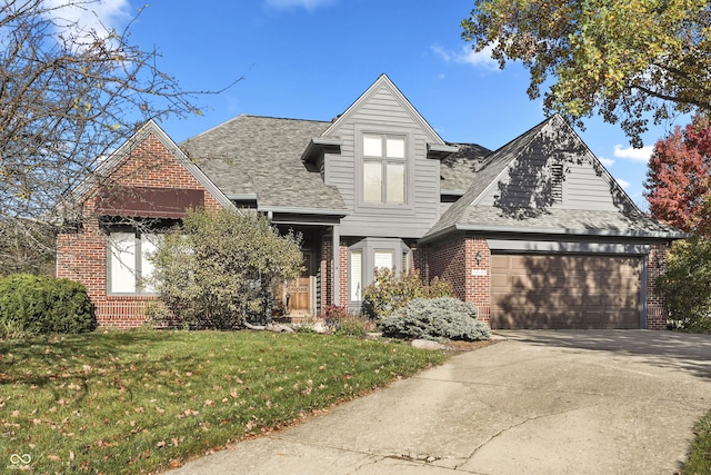 view of front facade featuring an attached garage, brick siding, concrete driveway, roof with shingles, and a front yard