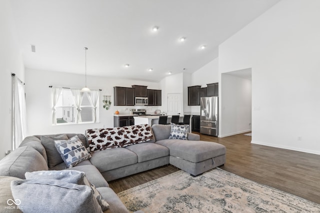 living room featuring dark hardwood / wood-style floors and high vaulted ceiling