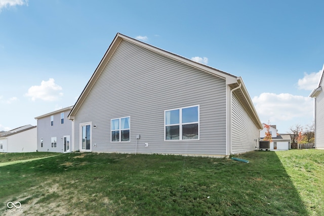 rear view of property with a lawn