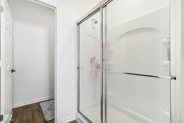 bathroom with walk in shower and wood-type flooring