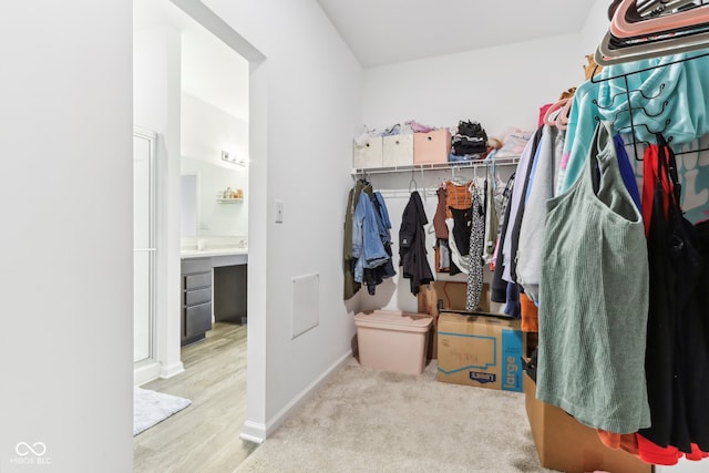 walk in closet featuring light hardwood / wood-style flooring