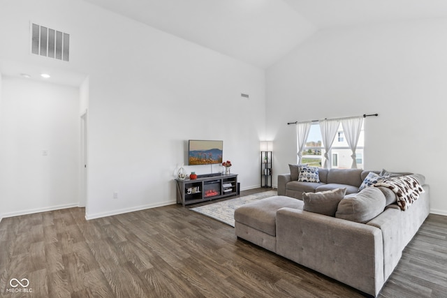 living room featuring hardwood / wood-style flooring and high vaulted ceiling