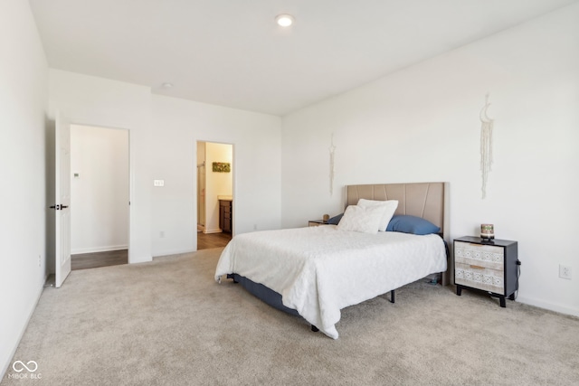 carpeted bedroom with ensuite bath