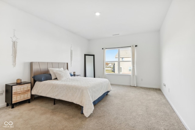 bedroom featuring light colored carpet