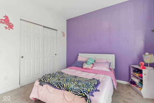 bedroom featuring light colored carpet and a closet