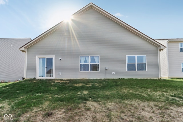 back of property featuring a lawn