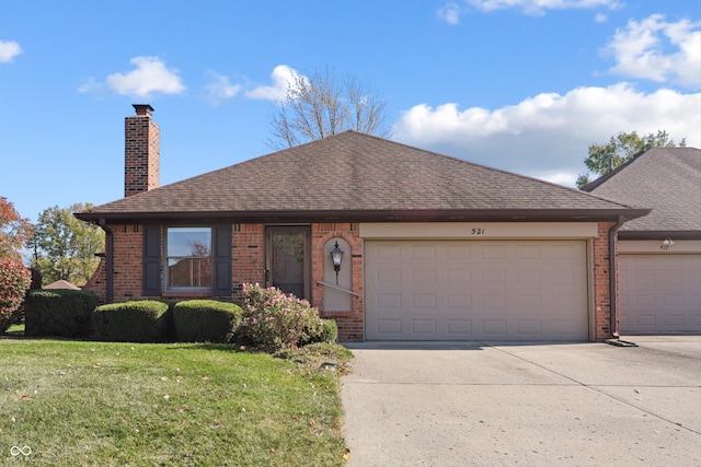 view of front of home with a front lawn and a garage